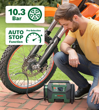 Man inflating a motorbike tyre with the Bosch PAO 18V cordless air compressor pump, with 10.3 bar max pressure, auto-stop pressure pre-selection and 3-year MyBosch warranty