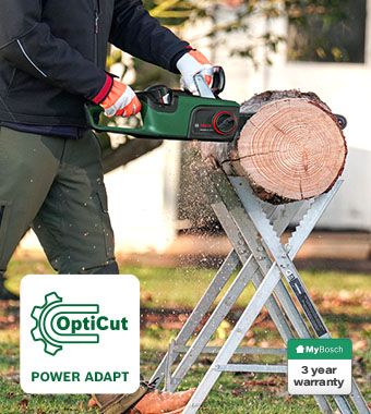 Bosch AdvancedChain 36V-35-40 36V Cordless Chainsaw – OptiCut Power Adapt Technology Bosch AdvancedChain 36V-35-40 36V cordless chainsaw cutting a large log on a sawhorse – OptiCut Power Adapt technology