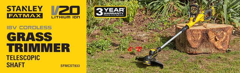 Stanley FatMax V20 SFMCST933 – Telescopic Shaft Cordless Trimmer Stanley FatMax V20 SFMCST933 18V cordless grass trimmer resting on a garden lawn beside a tree stump, surrounded by planted borders